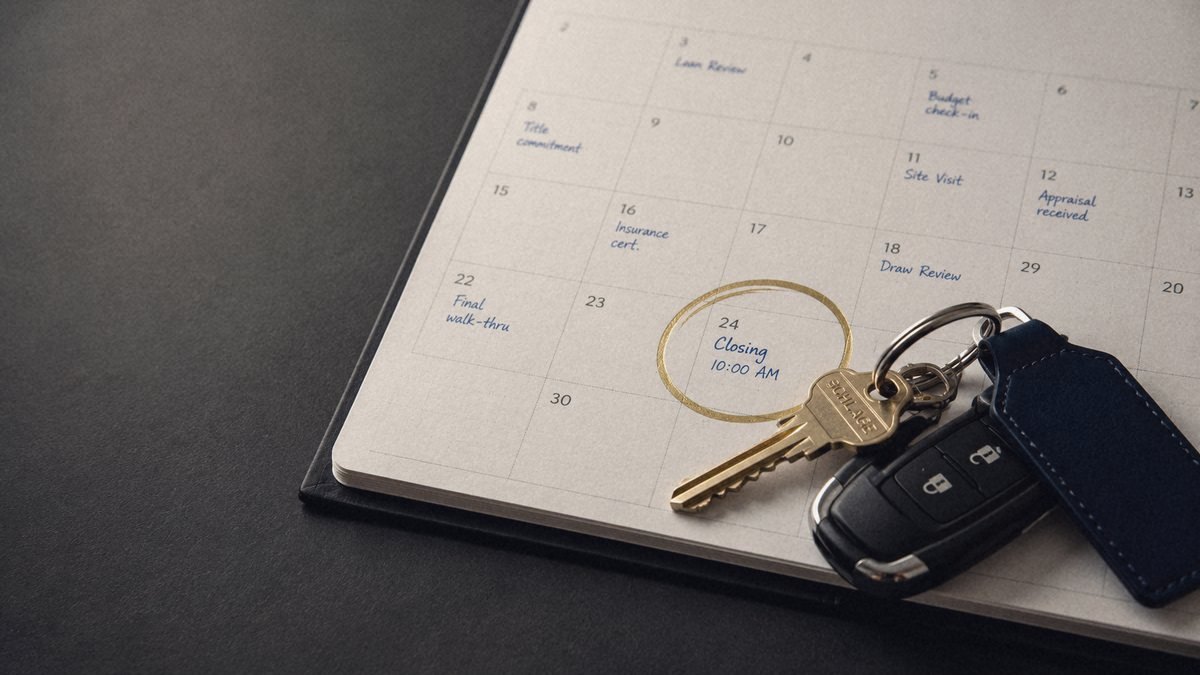 A calendar with a closing date circled in gold and a set of keys, representing a commercial deal closing on a deadline